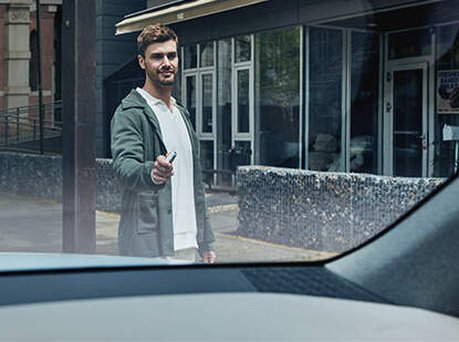 Image of someone using the Remote Smart Park Assist feature on keys.