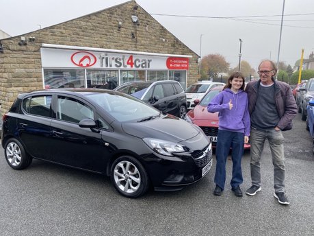 Emily and her dad collecting her new car on a miserable wet day