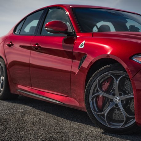 A red Alfa Romeo Quadrifoglio parked up. 