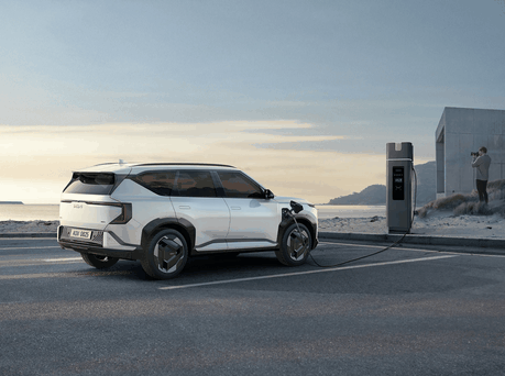 Image of Kia EV5 plugged into charger.