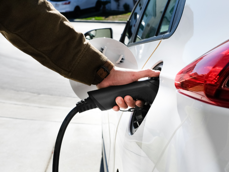 Image of someone charging an EV.