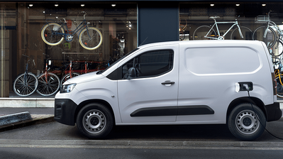 white new citroen e-berlingo electric - side view, charging