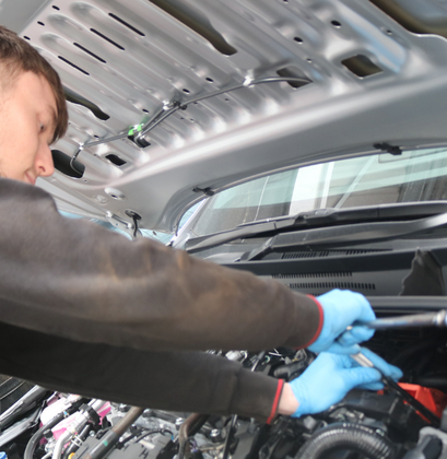 Image of technician working on a car repair.