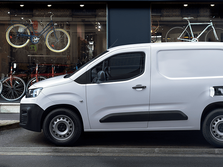 white new citroen e-berlingo electric - side view, charging