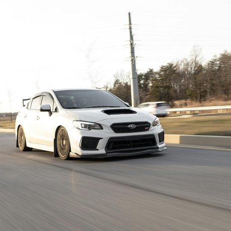 A white Subaru Impreza STI on the road.