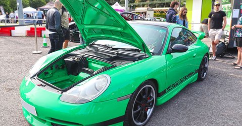 Green Porsche 911 GT3 RS with bonnet open displayed at Simply Porsche 2025, Beaulieu Motor Museum.