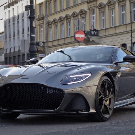 An Aston Martin driving in London City Centre.