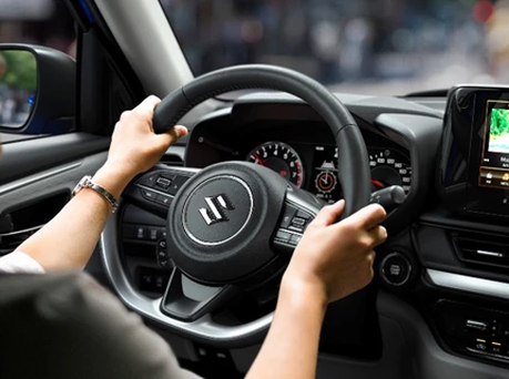Image of someone with their hands on the Swift steering wheel.