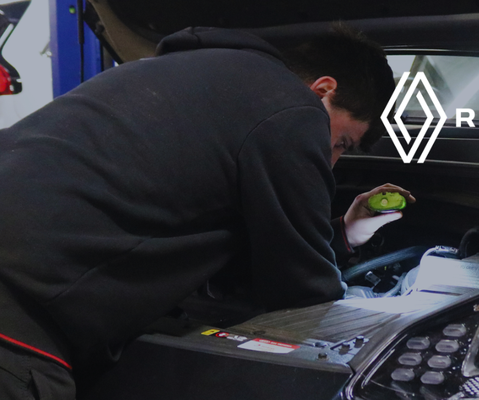 Image of a car being worked on with the Renault logo.